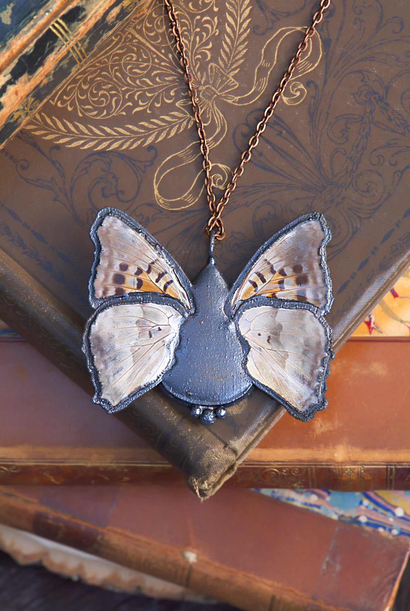 Plume agate and butterfly wing necklace